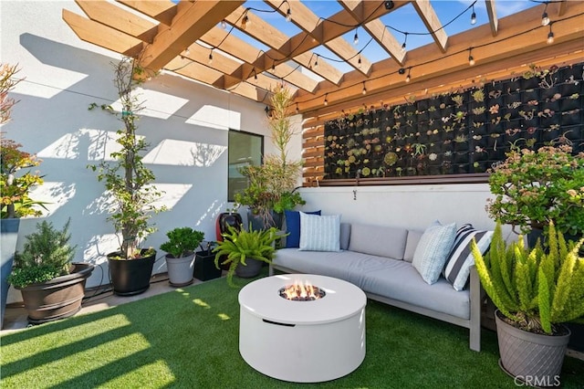 view of patio / terrace featuring an outdoor living space with a fire pit and a pergola