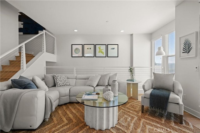 living area featuring recessed lighting, stairway, and baseboards