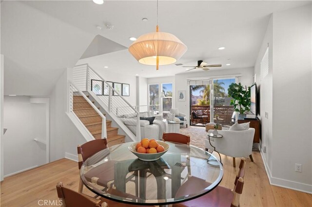 dining space featuring stairway, recessed lighting, light wood-style floors, and baseboards