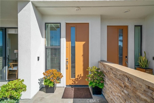 view of exterior entry with stucco siding