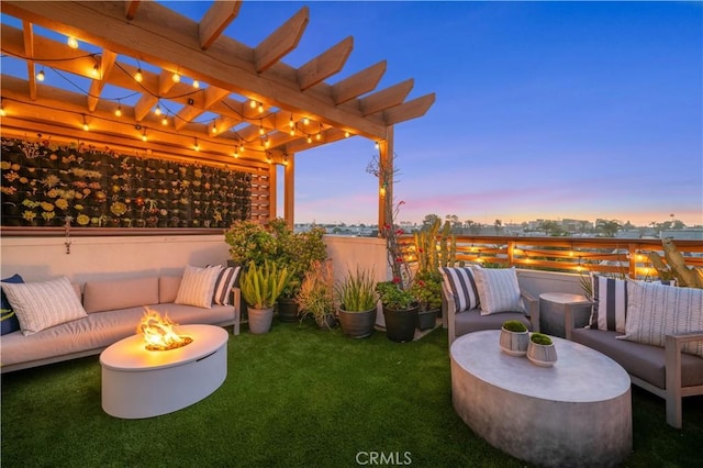 view of patio featuring a view of city, an outdoor living space with a fire pit, and a pergola