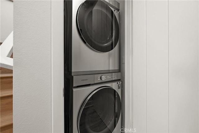 washroom with stacked washer / drying machine and laundry area