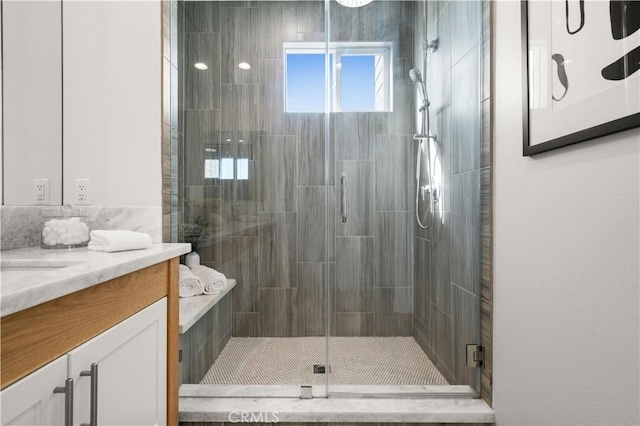 full bath with vanity and a stall shower