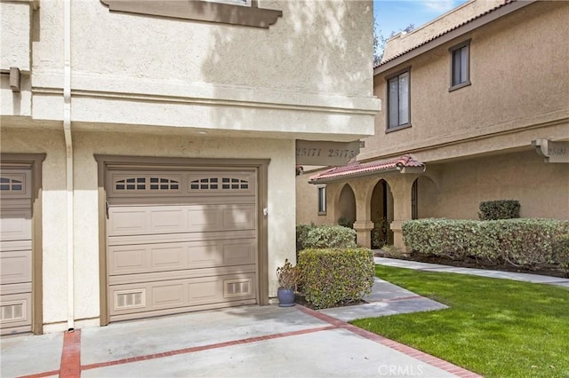 exterior space featuring a garage and stucco siding