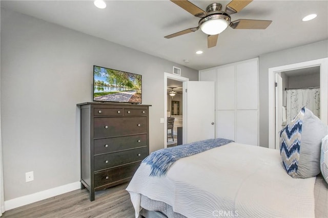 bedroom featuring recessed lighting, visible vents, baseboards, and wood finished floors