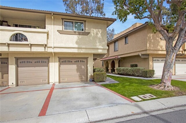 view of property featuring an attached garage and stucco siding