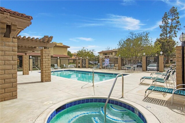 community pool featuring a community hot tub, a patio, fence, and a pergola