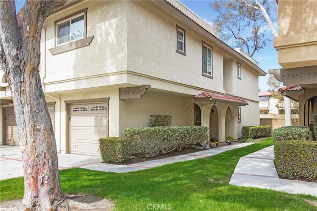 view of front of property featuring a garage and stucco siding