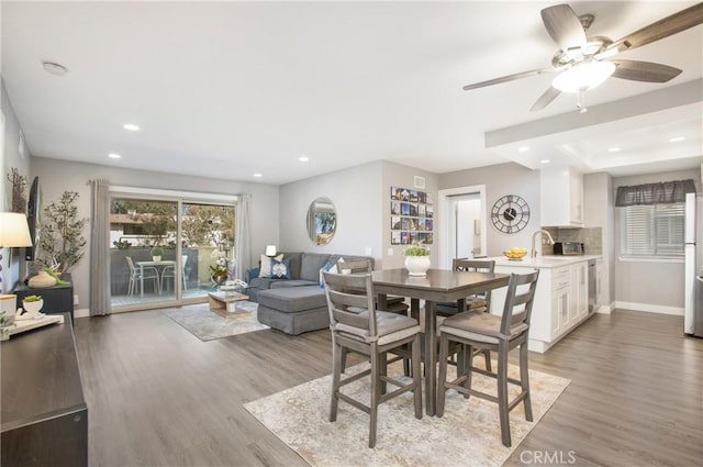 dining room featuring recessed lighting, light wood-style flooring, and baseboards