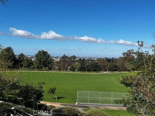 view of community featuring a yard and fence