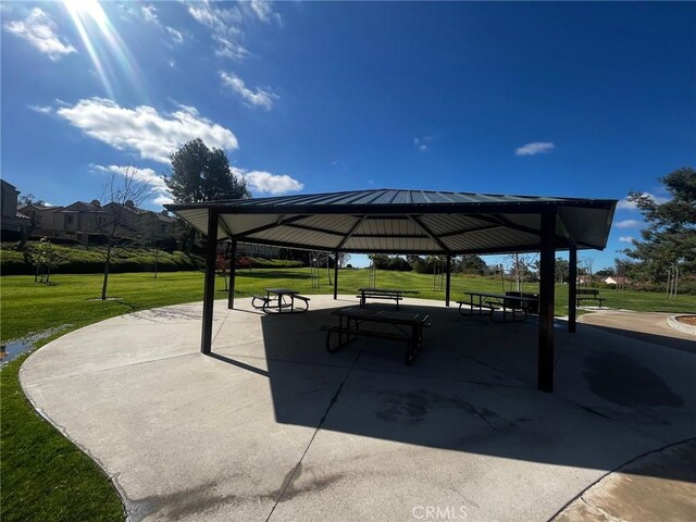 surrounding community with a gazebo and a yard