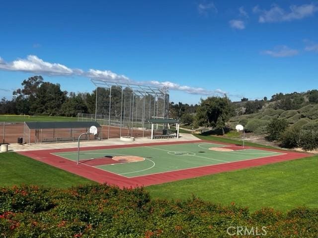 view of sport court with community basketball court, a yard, and fence