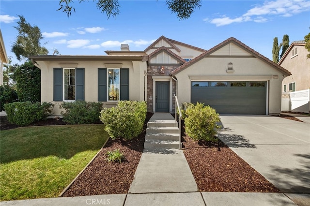 view of front of house with a garage, driveway, stone siding, stucco siding, and a front yard