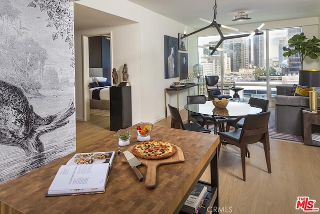 dining space with wood finished floors