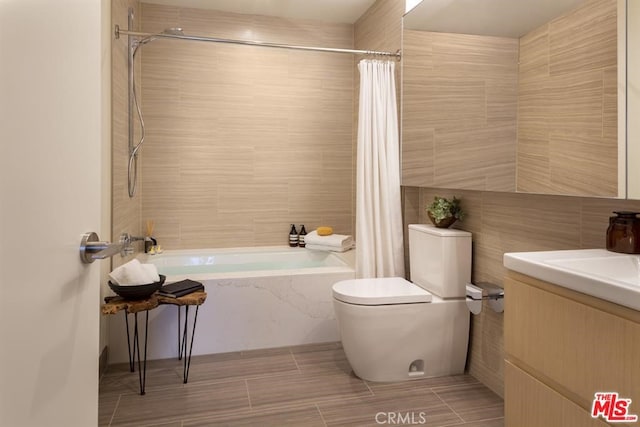 bathroom with shower / tub combo with curtain, tile walls, toilet, and vanity