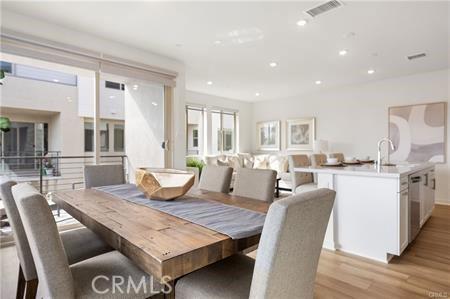 dining room featuring light wood-type flooring, visible vents, and recessed lighting