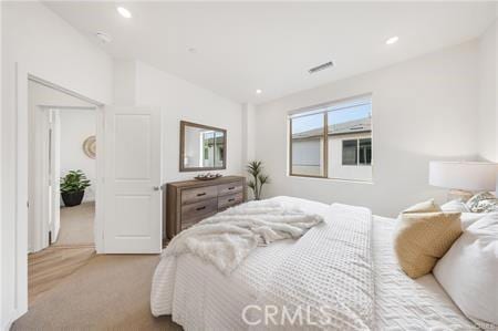 bedroom featuring recessed lighting, carpet flooring, vaulted ceiling, and visible vents