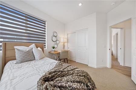 bedroom with carpet flooring and baseboards