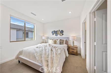 bedroom with carpet, visible vents, and baseboards