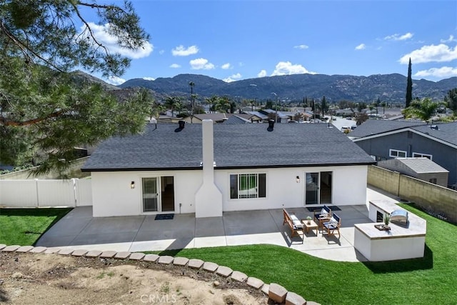 6215 Keystone St, Simi Valley, CA 93063 - back of house with stucco siding, roof with shingles, a mountain view, and a patio area