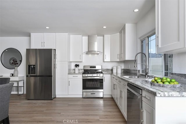 6215 Keystone St, Simi Valley, CA 93063 - kitchen featuring stainless steel appliances, wall chimney range hood, a sink, light stone countertops, and white cabinets