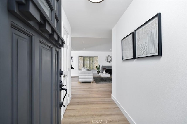 6215 Keystone St, Simi Valley, CA 93063 - foyer with a fireplace, light wood-style flooring, baseboards, and recessed lighting