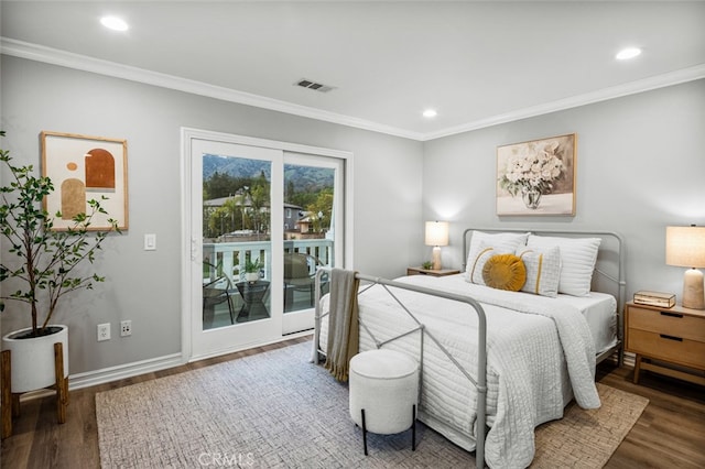 bedroom featuring baseboards, ornamental molding, wood finished floors, and access to exterior