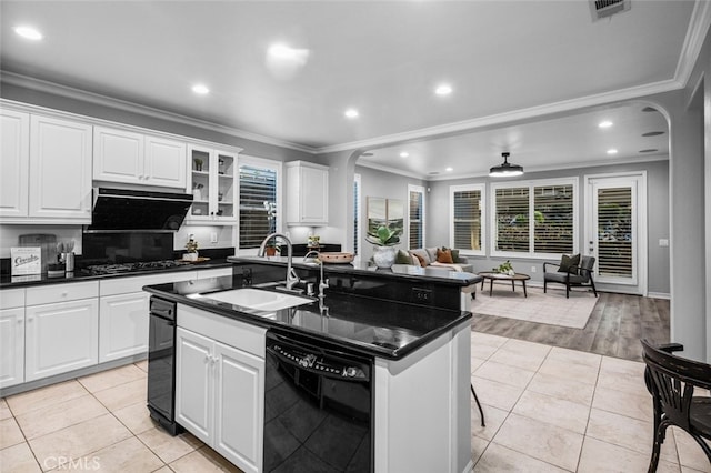 kitchen with dark countertops, a sink, visible vents, and dishwasher