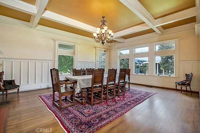 dining space with an inviting chandelier, plenty of natural light, and beamed ceiling