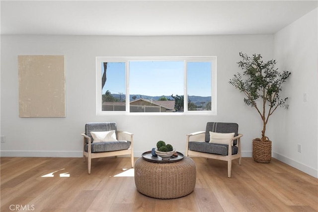 sitting room with light wood-style flooring and baseboards