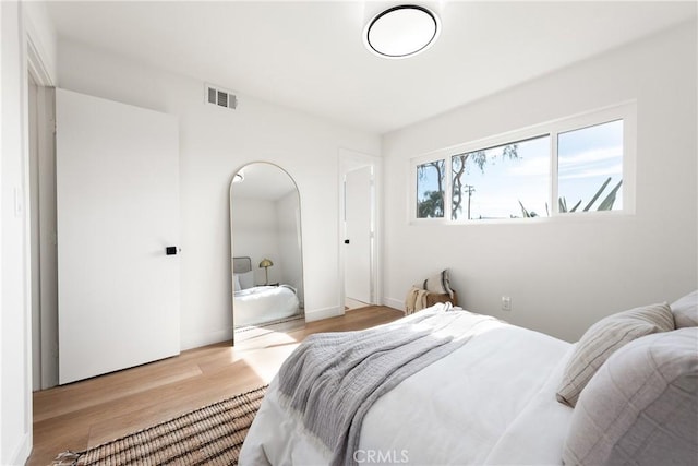 bedroom with visible vents and light wood-type flooring