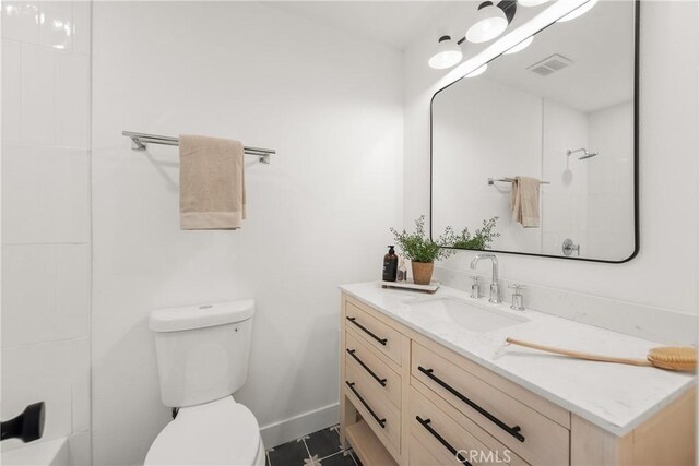 bathroom with visible vents, baseboards, walk in shower, toilet, and vanity