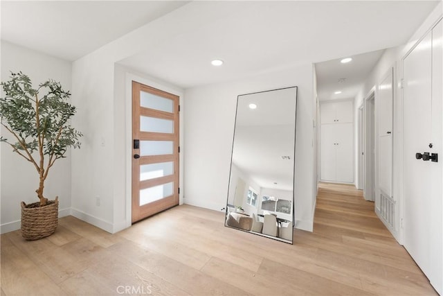 foyer with recessed lighting, visible vents, baseboards, and light wood-style floors