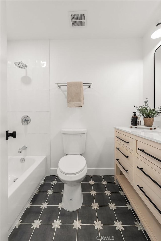 bathroom featuring visible vents, baseboards, toilet, and vanity