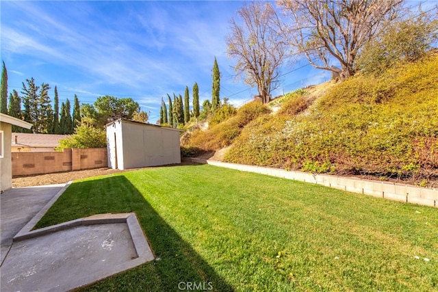 view of yard featuring a storage shed, an outdoor structure, and fence