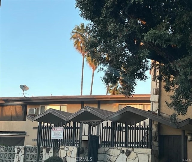 exterior space featuring fence and stucco siding