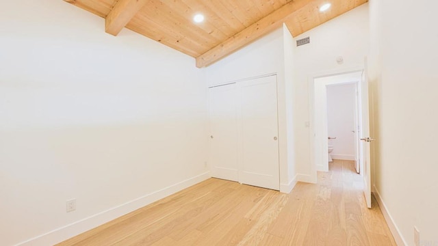 empty room with vaulted ceiling with beams, wooden ceiling, light wood-style flooring, visible vents, and baseboards