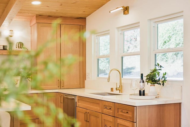 kitchen with light countertops, wooden ceiling, a sink, and a healthy amount of sunlight