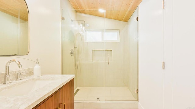 bathroom with vaulted ceiling, wood ceiling, a shower stall, and vanity