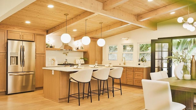 kitchen with light countertops, wooden ceiling, stainless steel fridge, and light wood-style floors