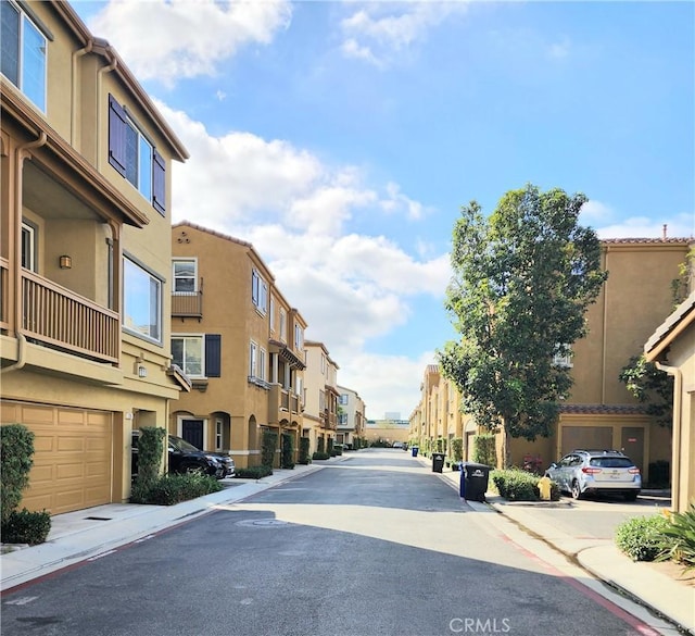 view of road with a residential view, curbs, and sidewalks