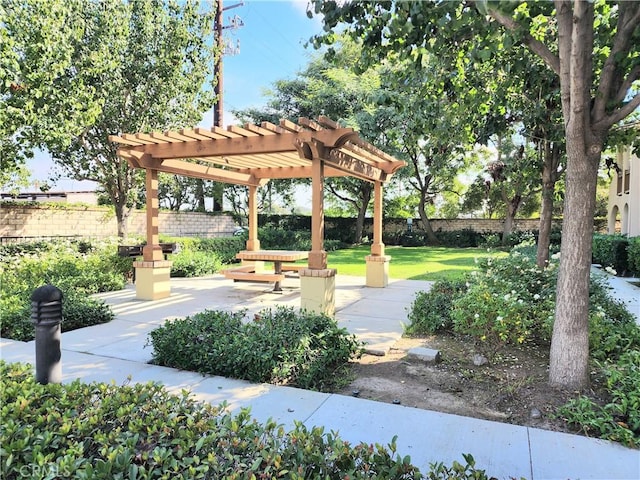 surrounding community featuring a patio area, a lawn, a pergola, and fence