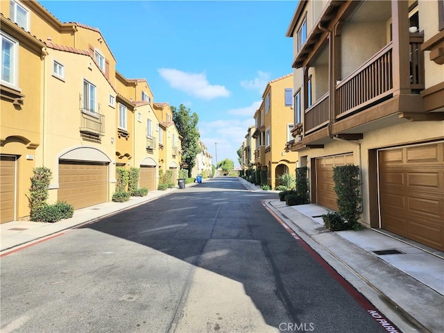 view of street with a residential view, curbs, and sidewalks