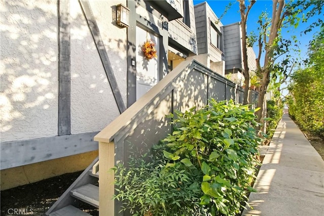 exterior details featuring fence and stucco siding