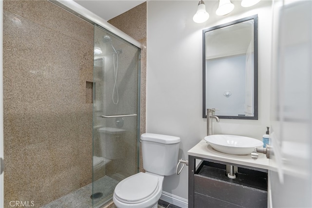 full bath featuring a stall shower, vanity, and toilet