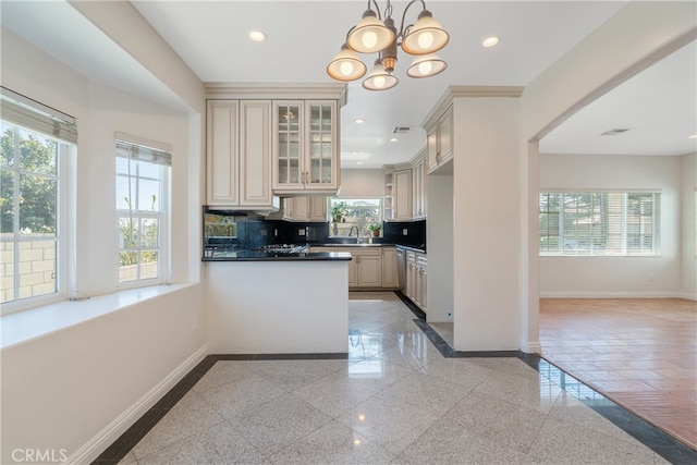 kitchen featuring tasteful backsplash, recessed lighting, granite finish floor, and baseboards