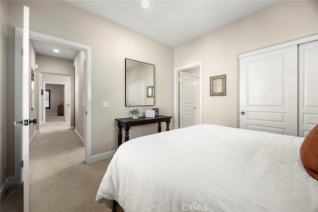 bedroom with a closet, recessed lighting, baseboards, and carpet floors