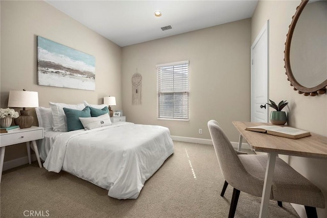 bedroom featuring visible vents, baseboards, and light colored carpet