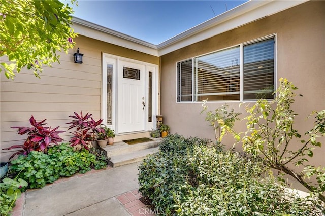 property entrance with stucco siding