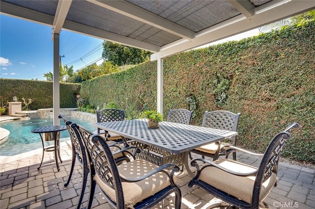 view of patio with outdoor dining area, a fenced backyard, and a fenced in pool